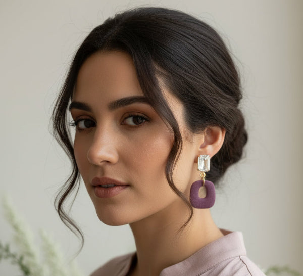model wearing mauve earring with clear crystal post