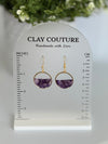 Amethyst and gold hoop earrings on a Clay Couture branded size stand