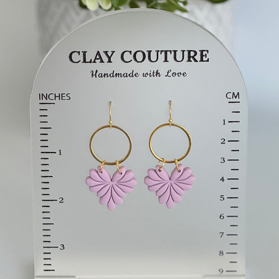 Mauve earrings on a Clay Couture Size Stand showing the height or length of the earrings