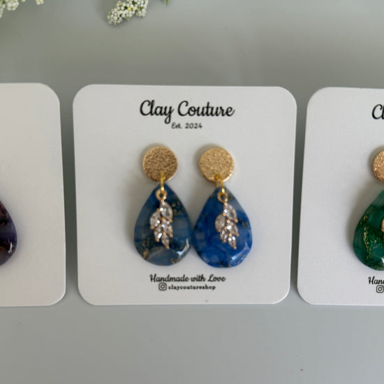 Teardrop shaped polymer clay earrings with resin finish and gold studs in three different colors 