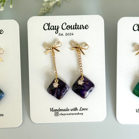 Three Pairs of Earrings on a Clay Couture branded cards
